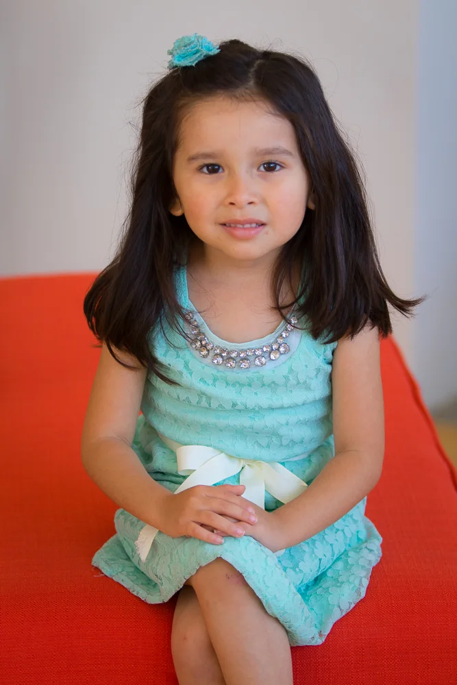 Young girl in a teal dress photographed by LovelaceMedia